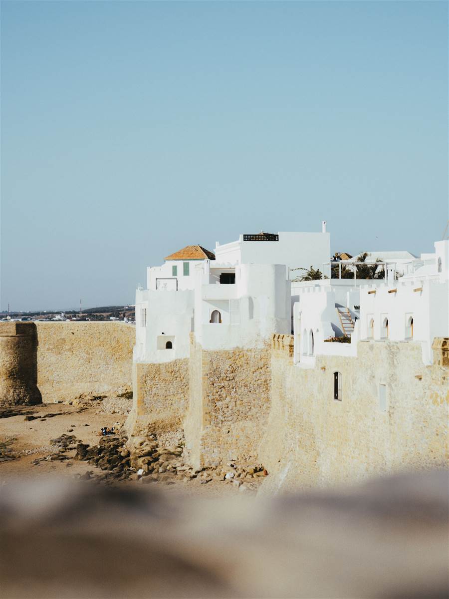 White medina houses on Portuguese sea ramparts in Asilah old town Morocco