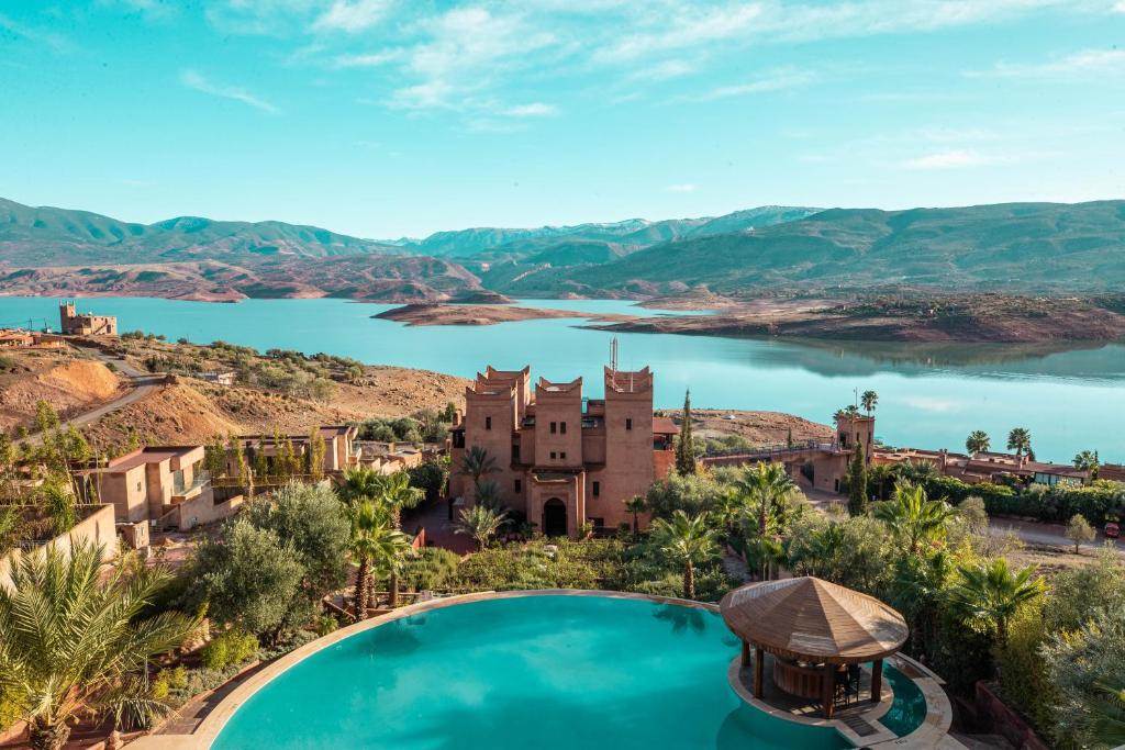 Kasbah hotel and pool above turquoise Bin El Ouidane lake, Atlas Morocco